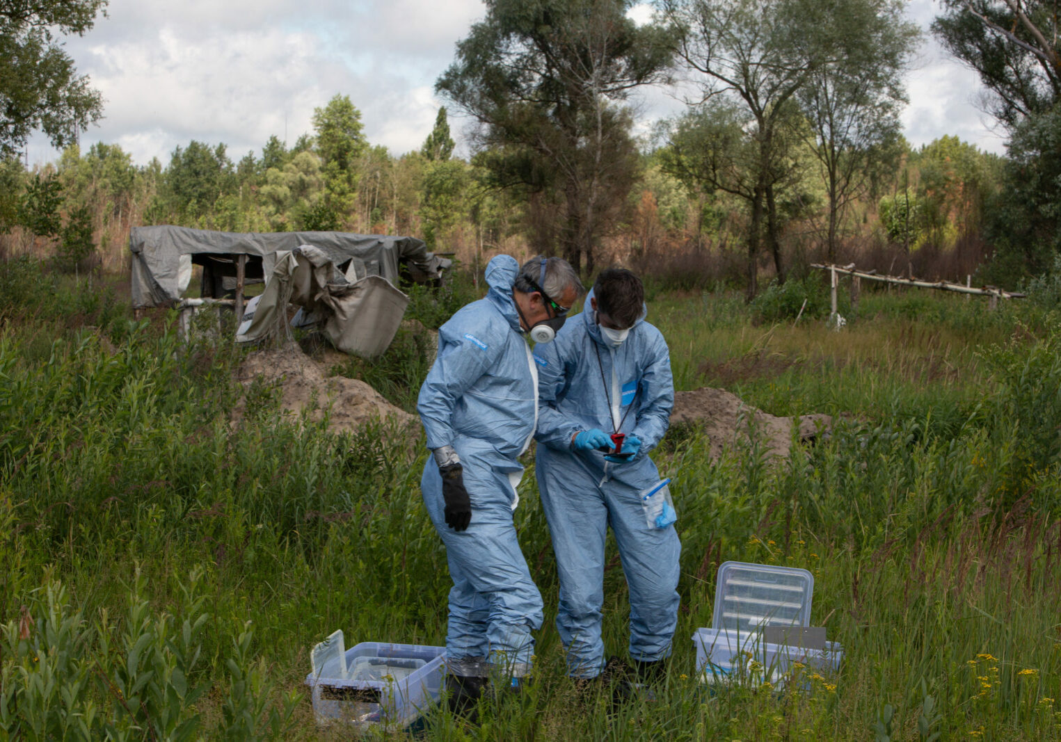 Jan Vande Putte (left) and Mathieu Soete, Radiation protection advisors from Greenpeace Belgium, at work taking samples of radioactive earth from the area where the Russian military dug trenches and built defensive structures in the March 2022 occupation.

The Greenpeace Chornobyl investigation team in the Chornobyl exclusion zone, working to extract earth samples to check for disturbed radiation in the area recently occupied by the Russian military, in Ukraine, 17 July 2022.